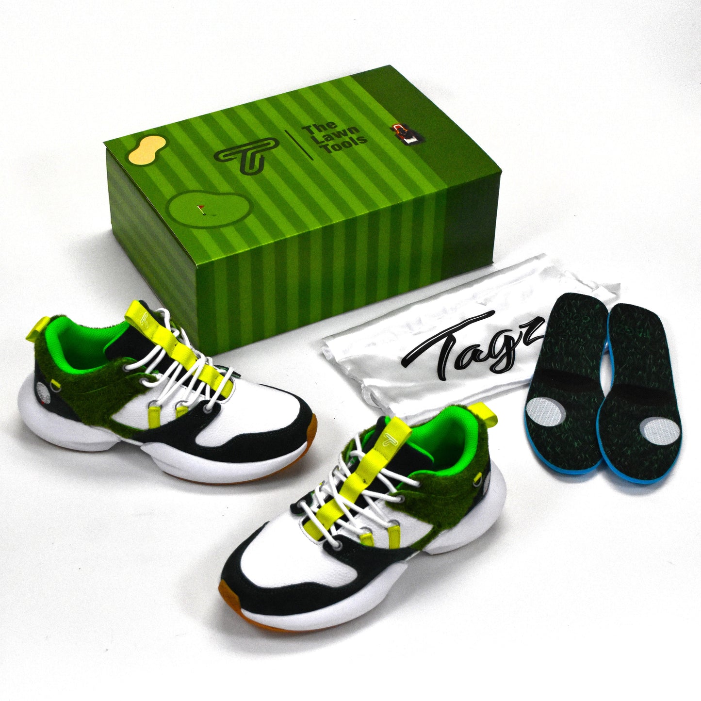 Green and black athletic shoes with a green box and white insole packaging on a white background