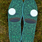 Green insoles with white dots and 'TAGZ' branding on a grass background